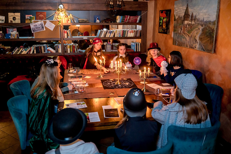 Дети разгадывают загадки в семейном квесте Хэллоуина в Krasnodar